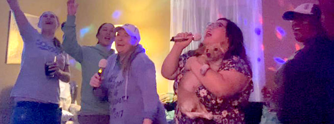 Image of family singing in living room.